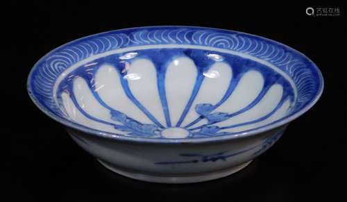 A Japanese Arita blue and white porcelain dish, decorated with a sixteen petal chrysanthemum mon and