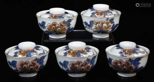 A set of five Japanese porcelain bowls and covers, decorated blue, peach and gold with branches of