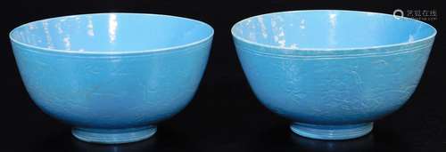 A pair of Chinese porcelain light blue ground bowls, with incised decoration of fruiting peach