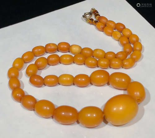 A BEESWAX CARVED DATE SHAPE NECKLACE