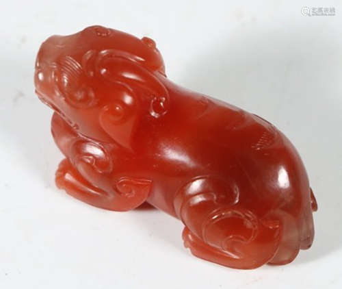 A RED AGATE CARVED BEAST SHAPE PENDANT