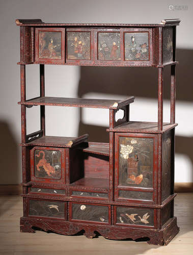 A RED LACQUER SHELF WITH FIGURE PATTERN