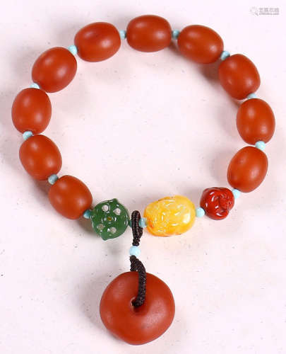 A BEESWAX CARVED BEAD STRING BRACELET