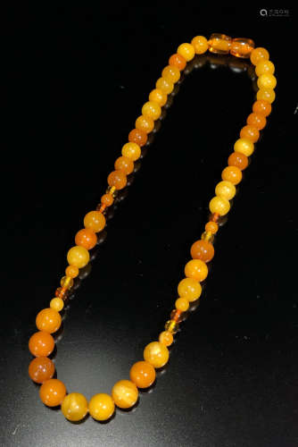 A BEESWAX CARVED NECKLACE