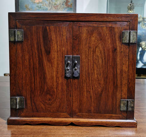 A HUANGHUALI WOOD CARVED CABINET WITH DOUBLE DOORS