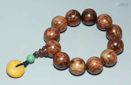 A HUANGHUALI WOOD WITH BEESWAX CARVED BRACELET