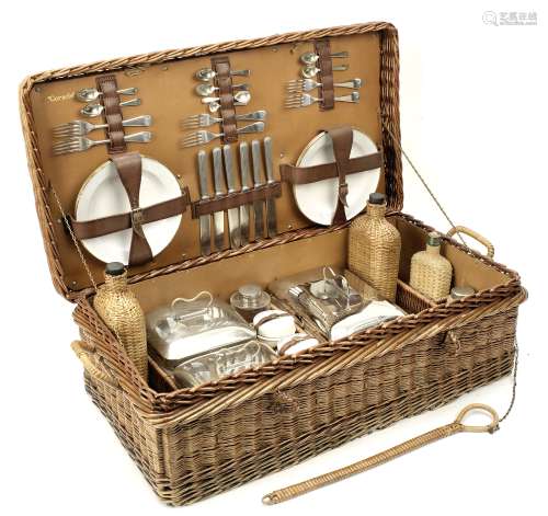 A wicker-cased 'Coracle' picnic set for six persons by G W Scott & Sons, circa 1909,