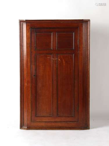 Property of a gentleman - a George III oak corner cabinet, with panelled single door, 48.25ins. (