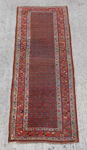 Property of a lady - an antique Hamadan long rug, with red boteh field, 116 by 43ins. (295 by