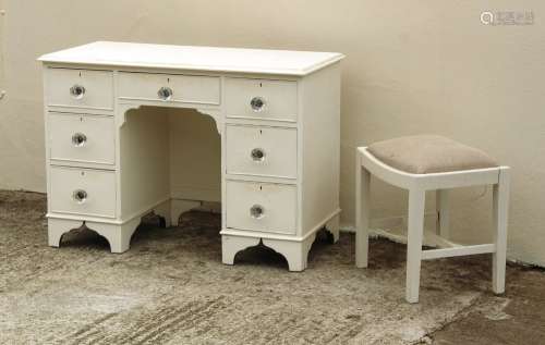 Property of a lady - a white painted kneehole dressing table; together with a similar stool (2).