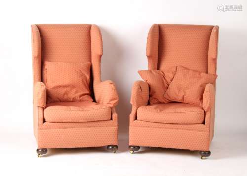 Property of a gentleman - a pair of early 20th century upholstered wing armchairs with bun feet &