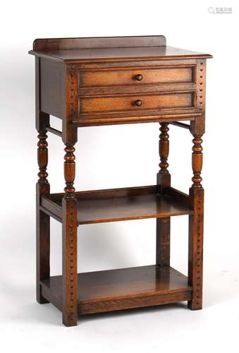 Property of a gentleman - an early 20th century oak open cabinet with two drawers above two open