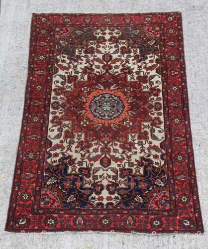 Property of a lady - a Persian Sarouk rug, with ivory field, 78 by 53ins. (198 by 135cms.).