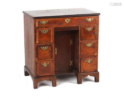 A small walnut & featherbanded kneehole desk, early 18th century & later, 30ins. (76cms.) wide (