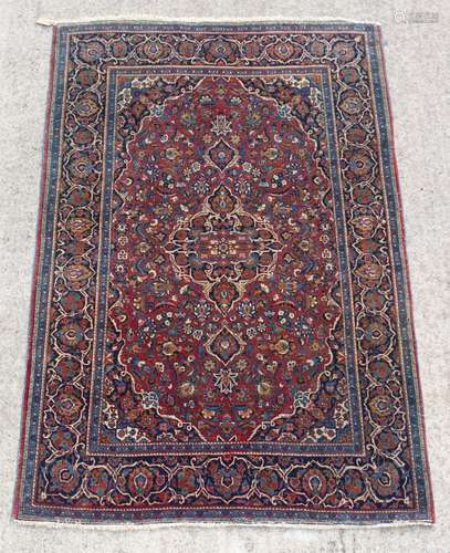 Property of a deceased estate - a Persian Kashan rug, with burgundy field, 82 by 53ins. (209 by