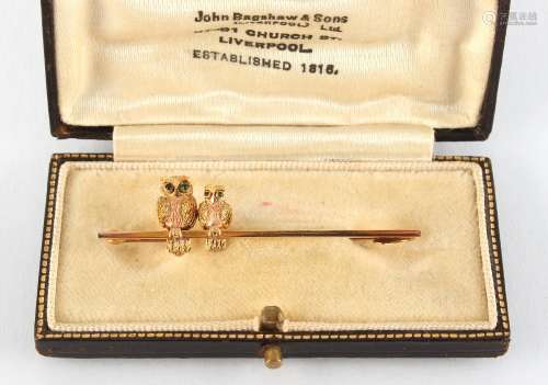 A 9ct two-colour gold bar brooch surmounted by two owls, the brooch approximately 50mm long, in