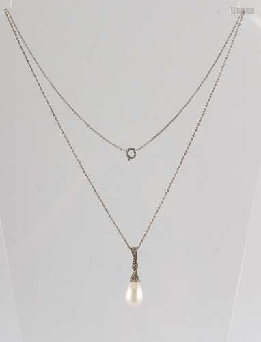 A large pearl & diamond pendant, the pear shaped pearl measuring approximately 13mm long (