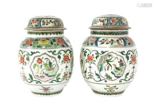 A pair of famille verte jars and covers,