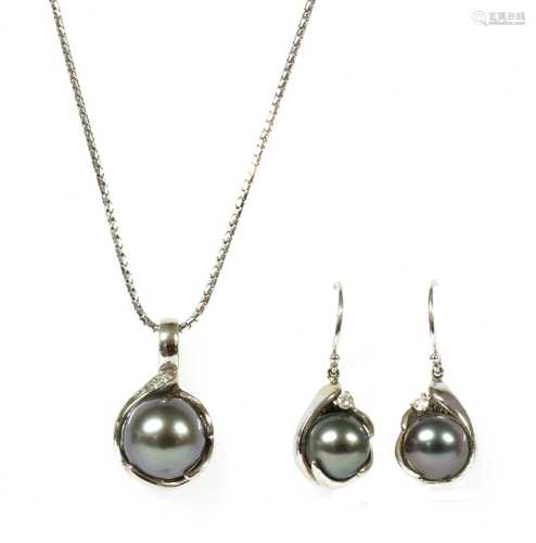 A white gold cultured pearl and diamond pendant and earring suite,