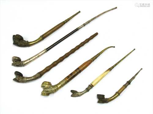 Six Burmese clay-mounted pipes,