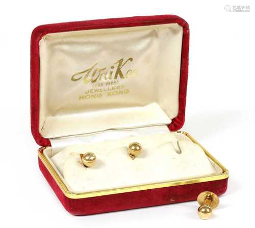 A cased set of three gold dress studs,