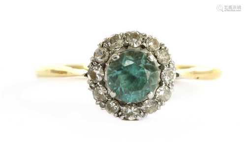 A gold blue zircon and diamond halo cluster ring,