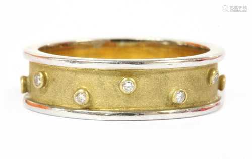 An 18ct two colour gold diamond set band ring,