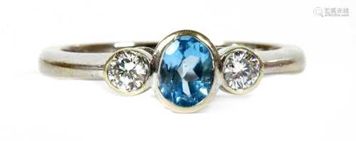 A 9ct white gold blue topaz and diamond three stone ring,