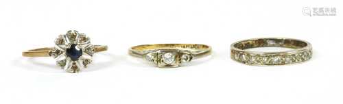 A gold three stone diamond ring,