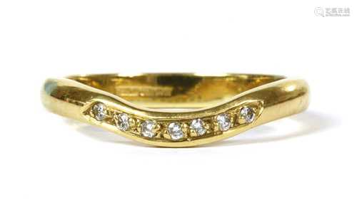 An 18ct gold diamond set shaped wedding ring,