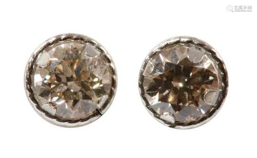 A pair of white gold diamond stud earrings,