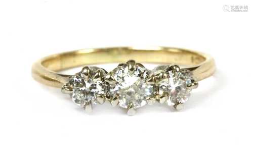 A gold three stone diamond ring,