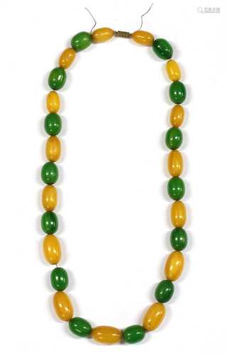 A single row slightly graduated oval yellow and green Bakelite bead necklace,