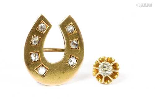 A gold diamond horseshoe brooch,