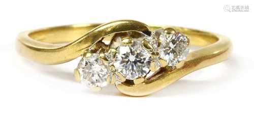 A gold three stone diamond ring,