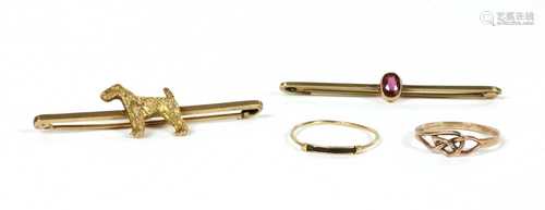 A gold dog bar brooch,