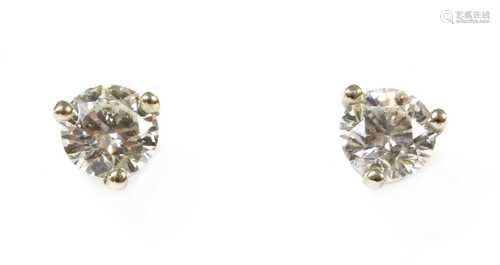 A pair of white gold single stone diamond stud earrings,