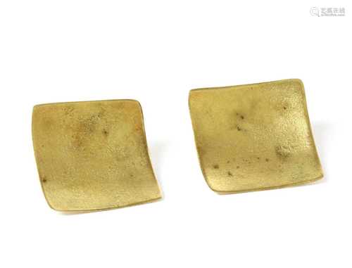 A pair of gold stud earrings,