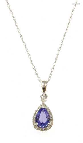 A white gold tanzanite and diamond pendant,