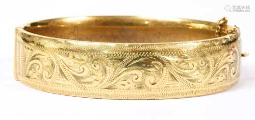 A 9ct gold oval hinged bangle,