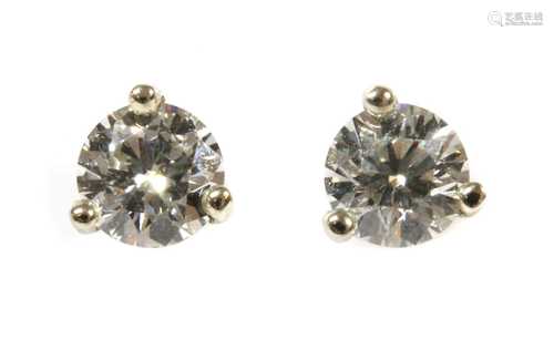 A pair of white gold single stone diamond stud earrings,