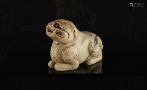 A Chinese carved mutton fat jade model of a recumbent beast, probably Ming Dynasty, 17th century,