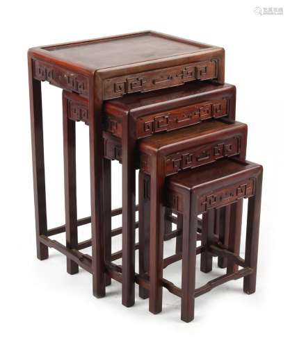 Property of a deceased estate - a nest of four Chinese carved hongmu occasional tables, the