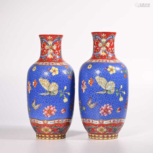 A pair of pink flower and butterfly decorative bottles