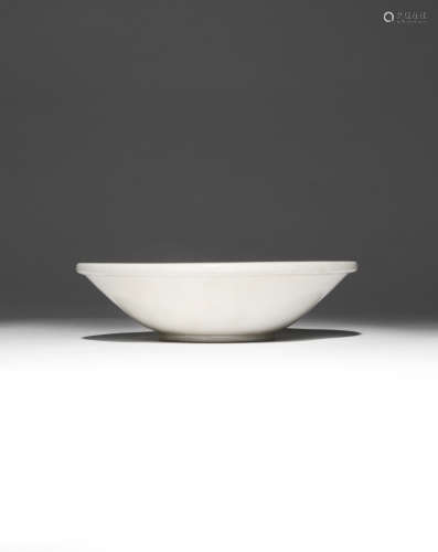 A CHINESE DING WHITE GLAZED BOWL LATE TANG DYNASTY The shallow body rising from a short circular