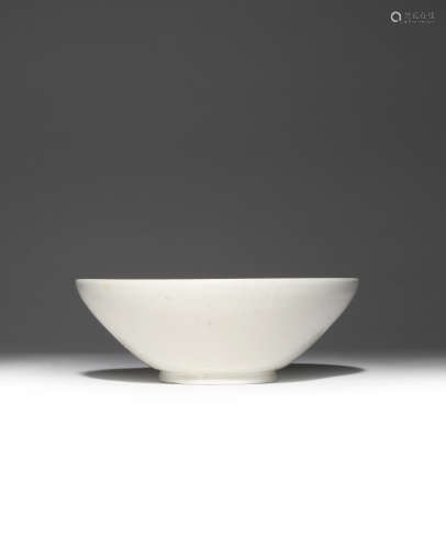 A CHINESE XING WHITE GLAZED BOWL FIVE DYNASTIES The deep body raised on a short flared foot,