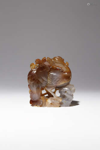 A CHINESE AGATE 'PHOENIX AND PEONY' CARVING 18TH CENTURY The mythical bird depicted standing on
