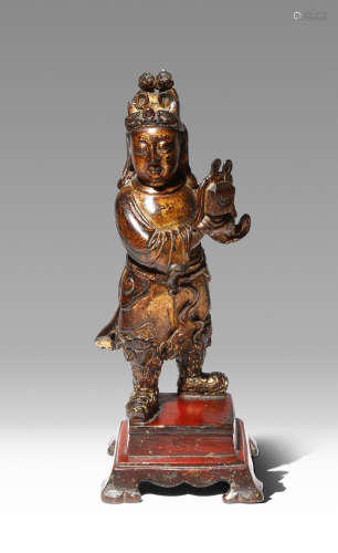 A LARGE CHINESE PARCEL-GILT AND LACQUERED-BRONZE FIGURE OF AN ATTENDANT 16TH/17TH CENTURY The