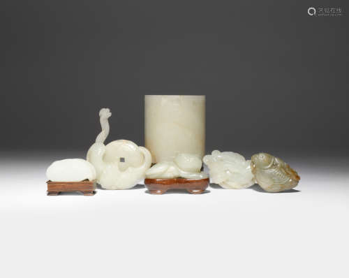 A GROUP OF SEVEN CHINESE JADE ITEMS 18TH/19TH CENTURY Comprising: a pale celadon carving of a cat, a