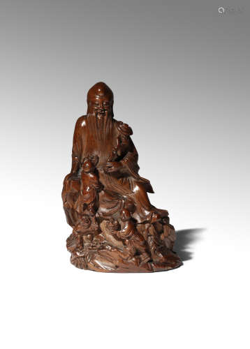 A CHINESE BAMBOO FIGURE OF SHOULAO 17TH/18TH CENTURY The God of Longevity carved seated on a rocky